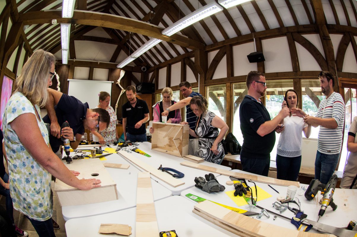 Corporate team building activity at Longleat with colleagues working together in a wildlife conservation setting, supporting CSR goals while surrounded by the park’s iconic safari landscape.