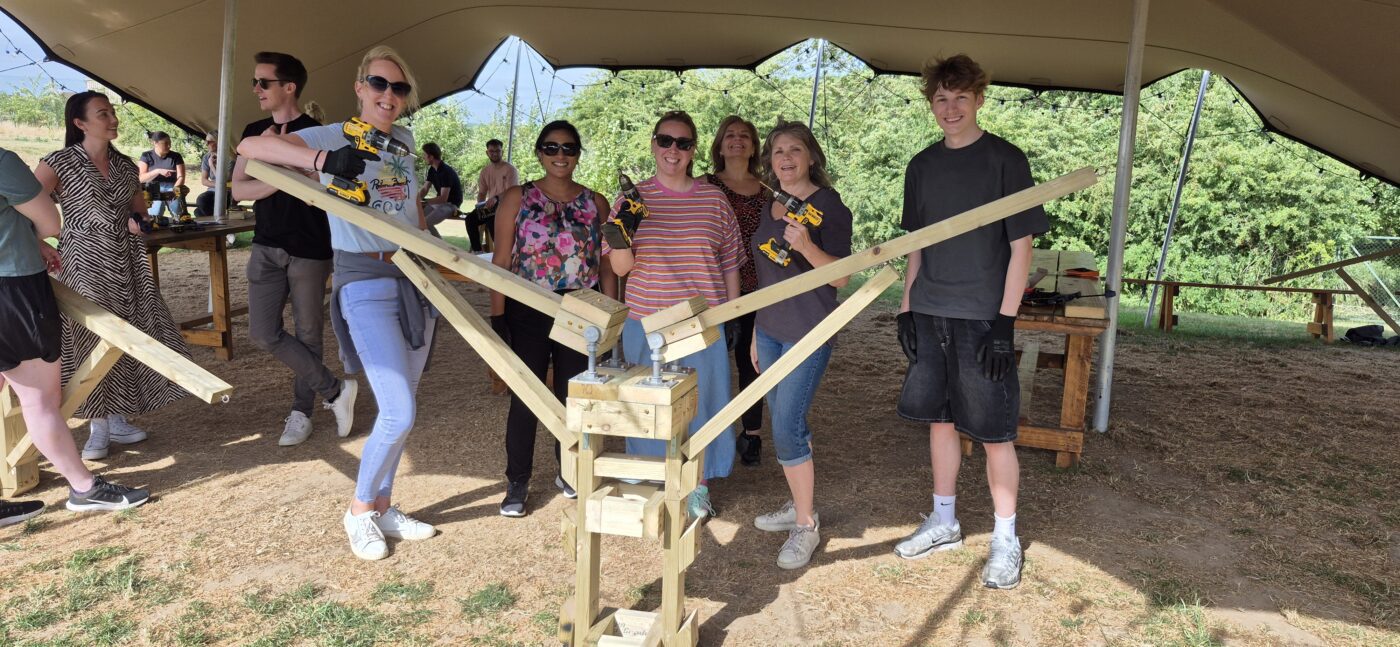 Employees collaborating during a CSR‑driven team‑building activity at Jimmy’s Farm Wildlife Park.