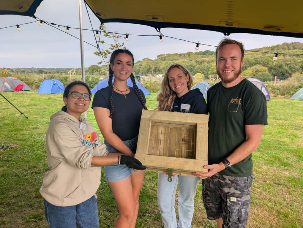 Corporate delegates engaging in outdoor team‑building tasks at Jimmy’s Farm’s countryside setting