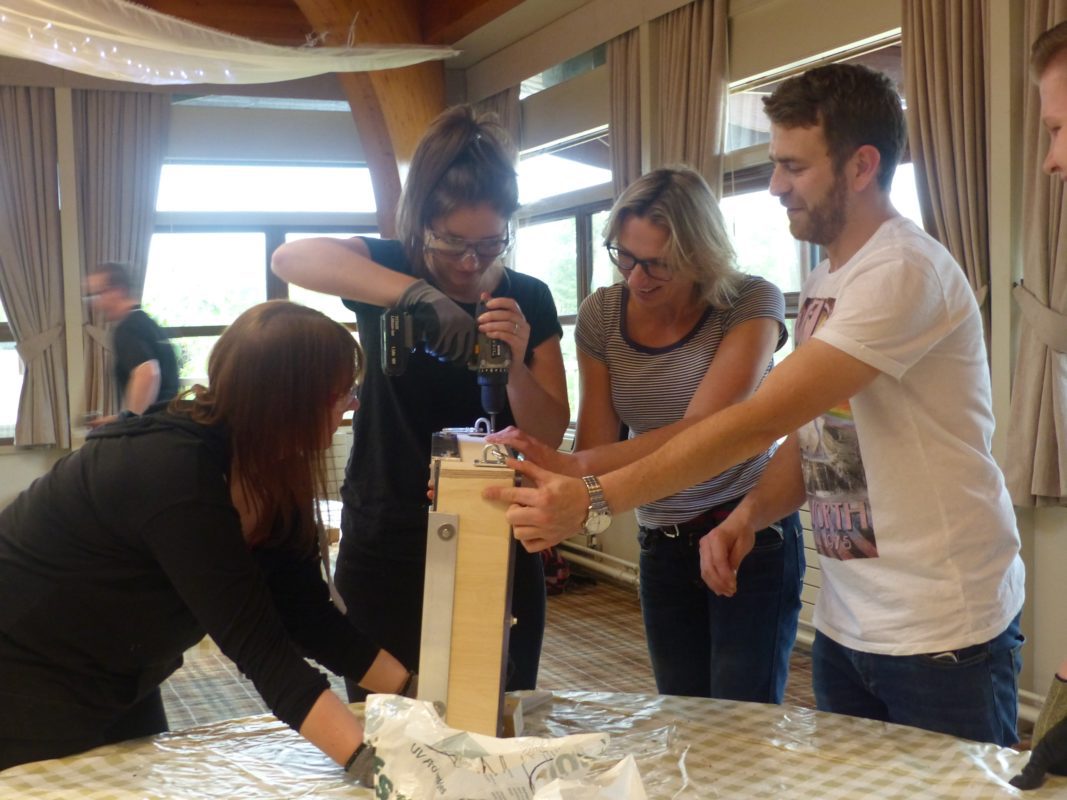 Corporate team taking part in a CSR team‑building event at Woburn Safari Park Employees collaborating on hands‑on conservation activity at Woburn Team building enrichment items for Woburn Safari Park animals during CSR workshop Purpose‑driven team‑building day supporting animal welfare at Woburn Staff working together on meaningful CSR activity in a safari park setting