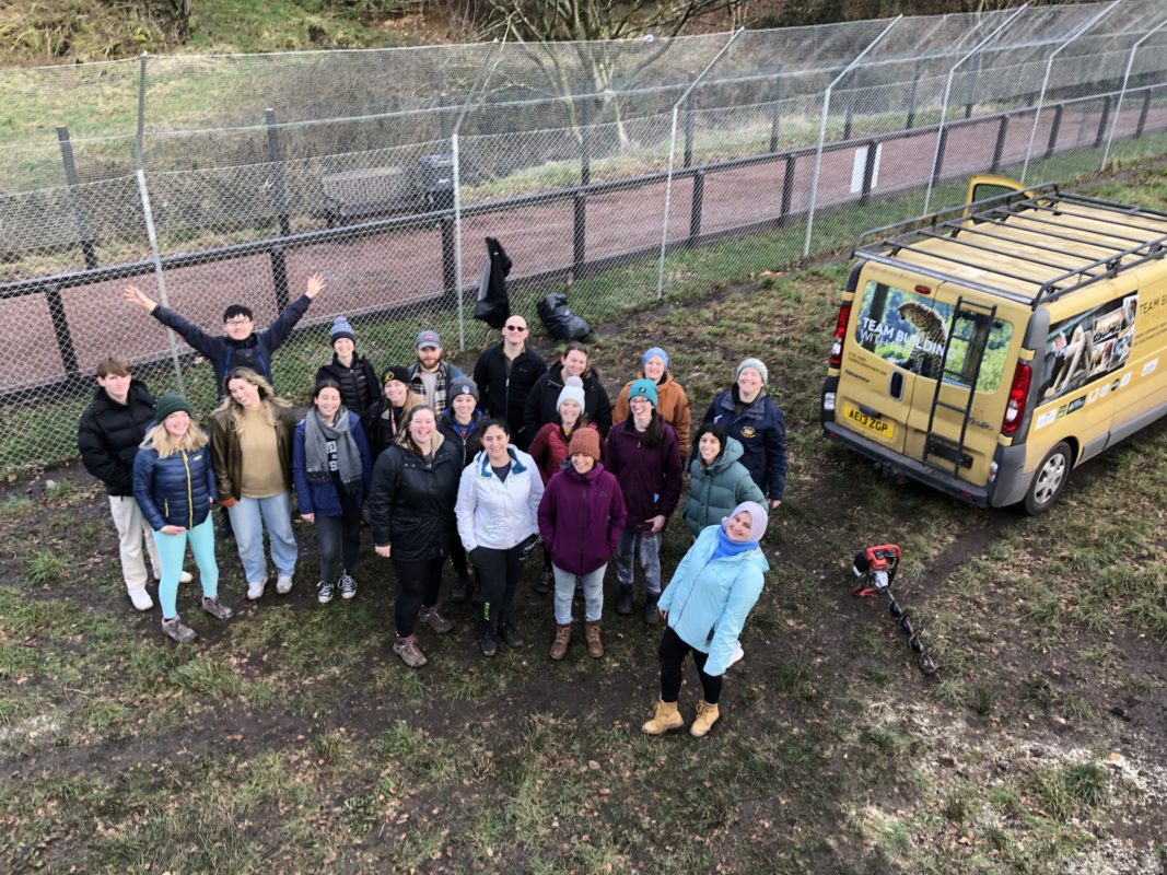 Corporate team taking part in a hands‑on team‑building challenge at Five Sisters Zoo to support conservation initiatives.
